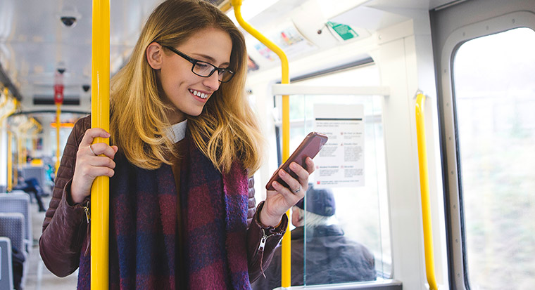 Woman on a bus using phone